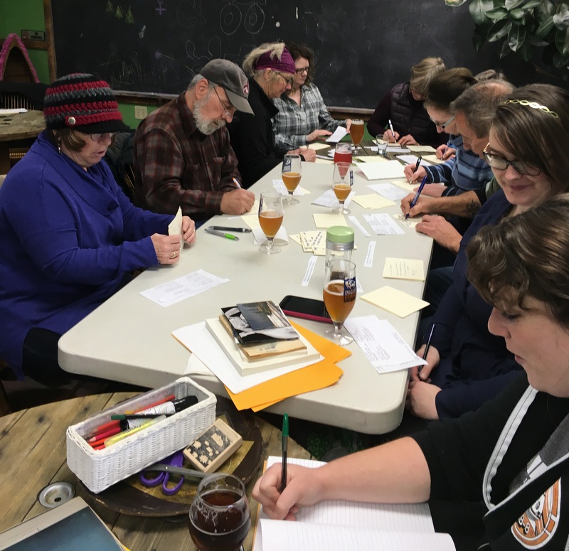 Writing postcards to electors at Imagine Nation Brewing.